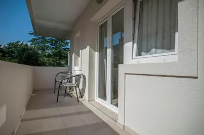 a balcony with a chair and a window at Mandir apartments - Center in Budva