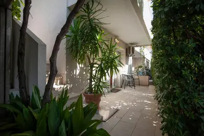 a hallway with trees and plants in a building at Mandir apartments - Center in Budva