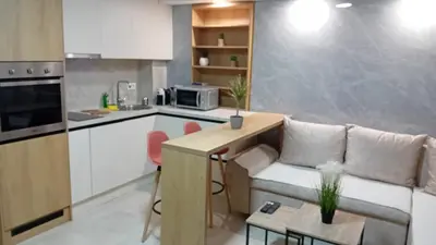 a living room with a couch and a kitchen at Square Point Apartments in Kotor