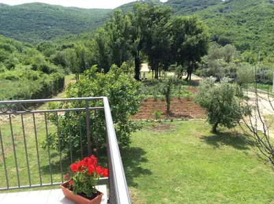 a balcony with a view of a garden at Apartments Raskovic I in Radanovići