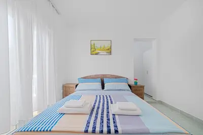 a bedroom with a bed with two towels on it at Apartment Dragicevic 2 with Garage in Budva