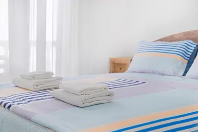 a bed with towels stacked on top of it at Apartment Dragicevic 2 with Garage in Budva