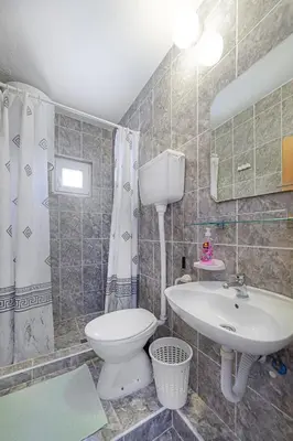 a bathroom with a toilet and a sink at Apartment Dragicevic 2 with Garage in Budva