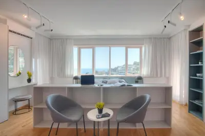 an office with two chairs and a desk with a computer at Fontana Seafront Residences in Budva