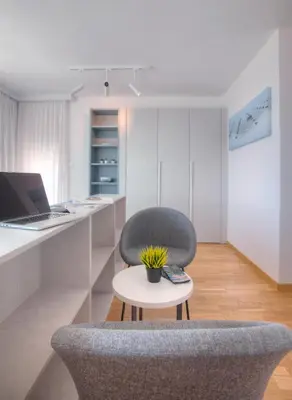 an office with a chair and a table with a laptop at Fontana Seafront Residences in Budva