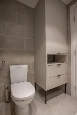 a bathroom with a white toilet in a room at Fontana Seafront Residences in Budva