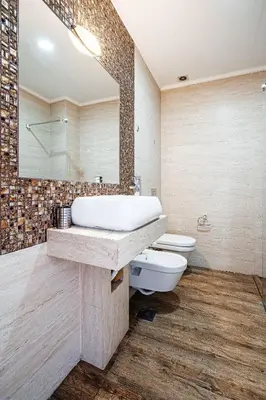 a bathroom with a sink and a toilet and a mirror at Victoria Top View in Budva