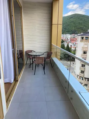 a balcony with a table and chairs and a view at Victoria Top View in Budva