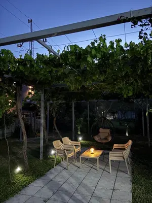 a patio with chairs and a table under a pergola at Apartmani Sara in Ulcinj