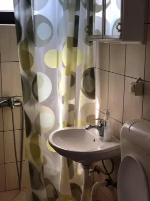 a bathroom with a sink and a shower curtain at Apartmani Sara in Ulcinj