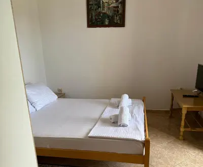 a bed with a teddy bear sitting on top of it at Apartmani Sara in Ulcinj