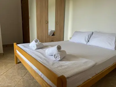 a bedroom with a bed with towels on it at Apartmani Sara in Ulcinj