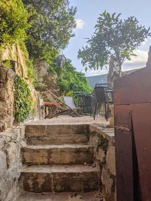 a set of stairs leading to a patio with a table at Best view! Rooftop with Garden - Old Town Nr404 in Kotor