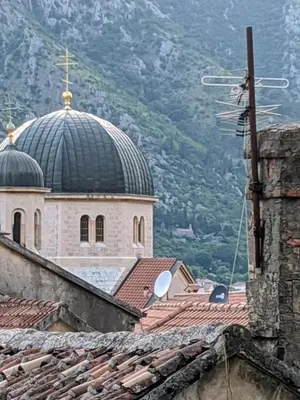 a church with a black dome on top of roofs at Romantic Rooftop View Hideaway- Old Town Nr 404 in Kotor