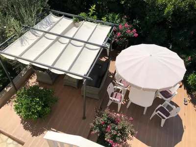an overhead view of a patio with an umbrella and chairs at Axenia Hotel in Utjeha