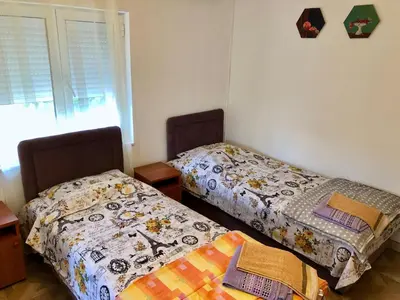 two beds sitting next to each other in a room at Axenia Hotel in Utjeha