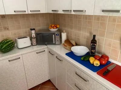 a kitchen with a counter with a microwave and fruit at Axenia Hotel in Utjeha