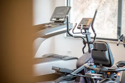 a gym with a treadmill and a phone at Plaza Hotel&SPA in Ulcinj