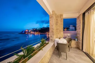 a balcony with a table and a view of the ocean at Plaza Hotel&SPA in Ulcinj