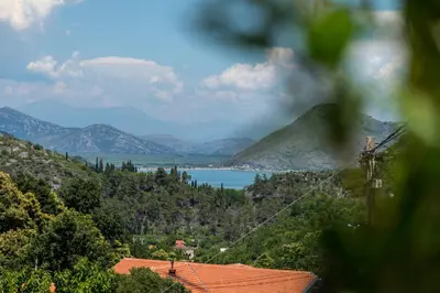 a view of a lake with mountains in the background at Green Hill in Virpazar