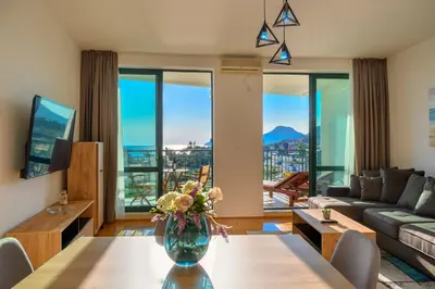 a living room with a vase of flowers on a table at Apartment Hanja in Bar