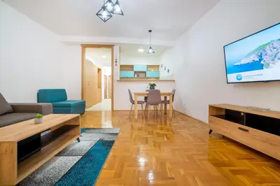 a living room with a couch and a tv on a wall at Apartment Hanja in Bar