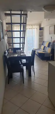 a living room with a table and chairs and a couch at Apartments Klakor PS in Tivat