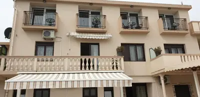 a large building with balconies and a white awning at Apartments Klakor PS in Tivat