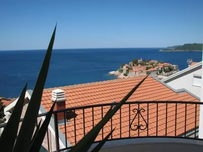 a view of the ocean from the balcony of a house at Apartments Leut in Sveti Stefan