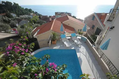 a view of a swimming pool from a house at Apartments Leut in Sveti Stefan