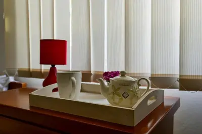 a tray with two cups and a tea set on a table at Apartments Leut in Sveti Stefan