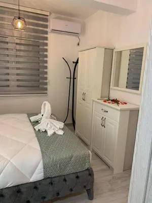 a bedroom with a bed with a robe on it at Apartment All Seasons in Ulcinj