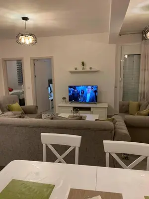 a living room with a couch and a tv at Apartment All Seasons in Ulcinj