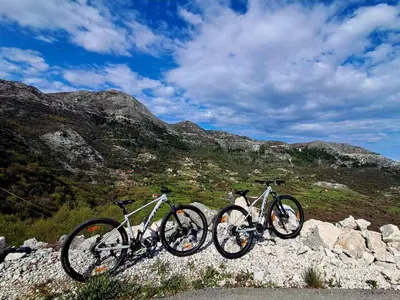 three bikes parked on top of a rocky mountain at Etno house HAPPY VILLAGE in Cetinje