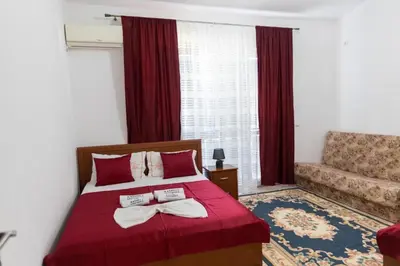 a bedroom with a bed with two towels on it at Kasneci Apartments in Ulcinj