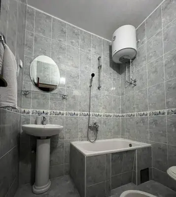 a bathroom with a sink and a tub and a toilet at Kasneci Apartments in Ulcinj