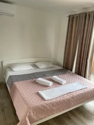 a bedroom with a bed with two towels on it at Lake River House Ada Bojana in Ulcinj