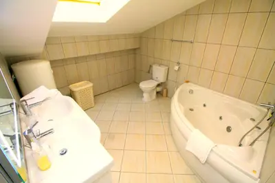 a bathroom with a tub and a toilet and a sink at Lux Pržno View Penthouse in Budva