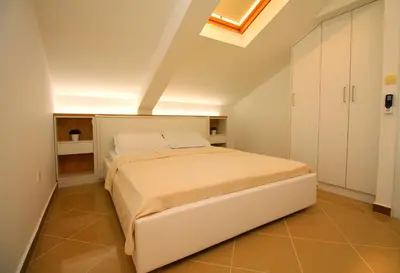 a bedroom with a large white bed in a room at Lux Pržno View Penthouse in Budva