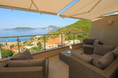 a balcony with couches and a view of the water at Lux Pržno View Penthouse in Budva