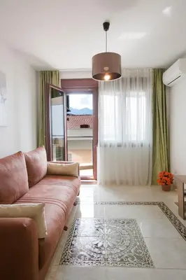 a living room with a couch and a window at Anatolia - Family Sea View one-bedroom apartment in Budva