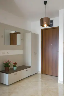 a living room with a counter and a wooden door at Anatolia - Family Sea View one-bedroom apartment in Budva