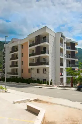 an apartment building on the side of a street at Anatolia - Family Sea View one-bedroom apartment in Budva