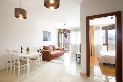 a living room with a couch and a table at Anatolia - Family Sea View one-bedroom apartment in Budva