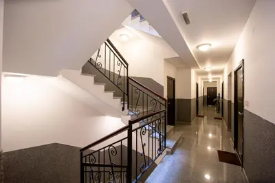 a staircase in a house with white walls and black railings at Lux View in Budva