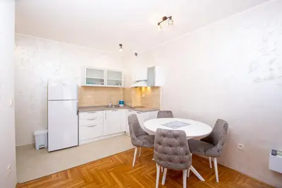 a kitchen with a table and chairs in a room at Lux View in Budva