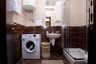 a bathroom with a washing machine and a sink at Lux View in Budva