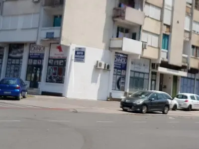 a street with cars parked in front of buildings at Renta stan apartman odmor in Podgorica