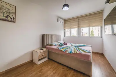 a small bedroom with a bed and a window at Renta stan apartman odmor in Podgorica