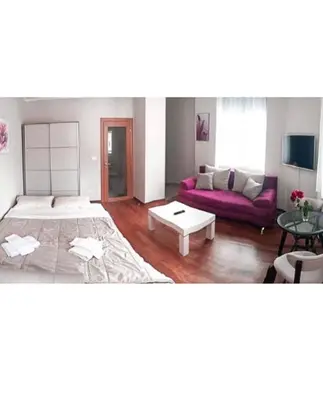 a living room with a couch and a table at Lux View in Petrovac na Moru
